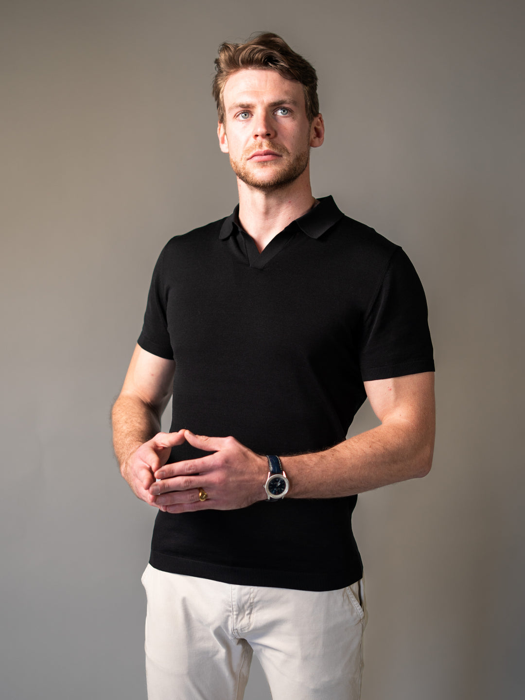 Black muscle fit knitted polo engineered for men with a V-shaped frame