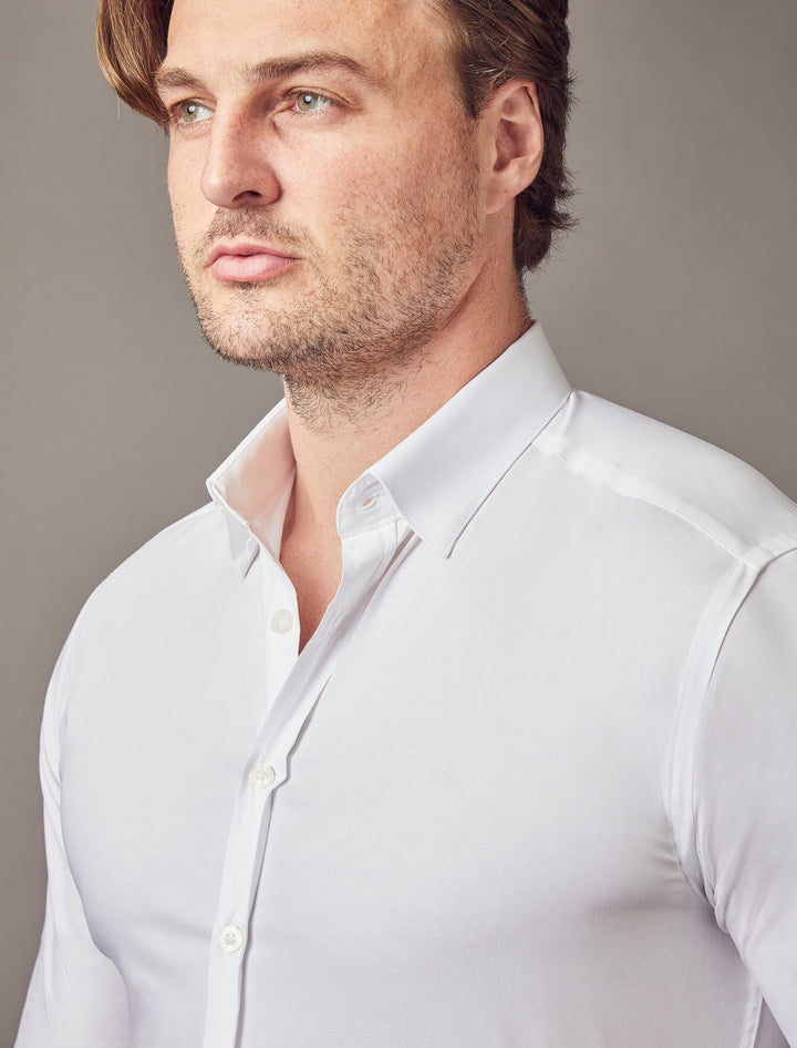 A white shirt with a tapered fit from Tapered Menswear, featuring a muscle-fit design for a blend of comfort and stylish silhouette.