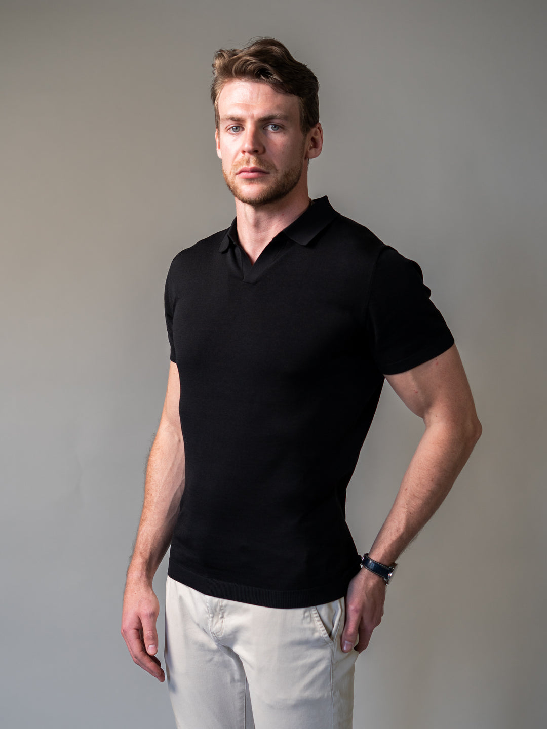 Black knitted polo with revere collar tailored for a sharp tapered fit
